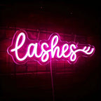 Neon sign with the word 'lasheshes' on a dark background