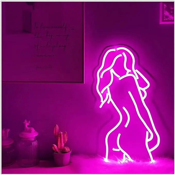 Neon light shaped like a woman's silhouette on a purple wall with decor items.