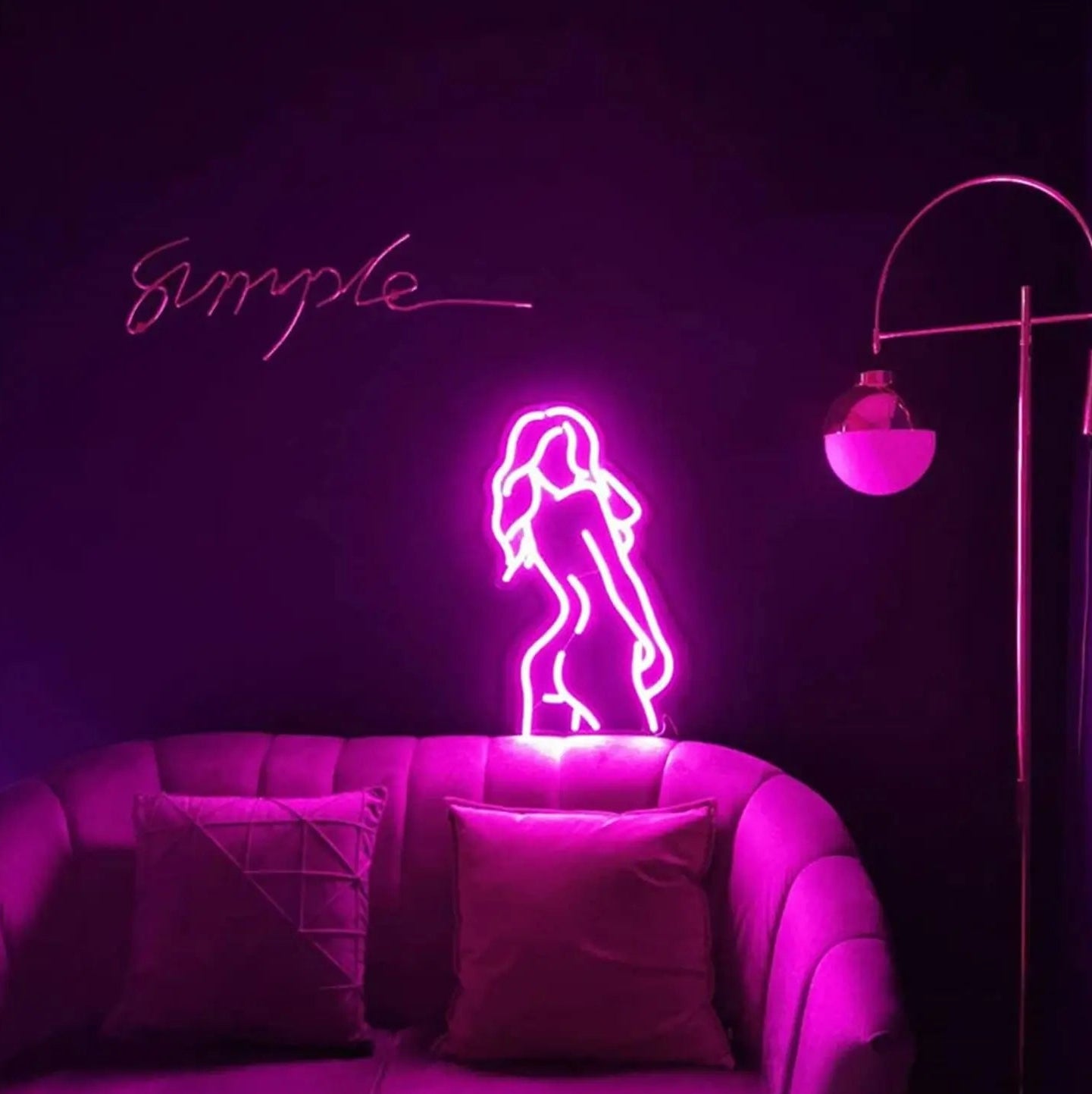 Neon sign of a woman on a couch with a dark background