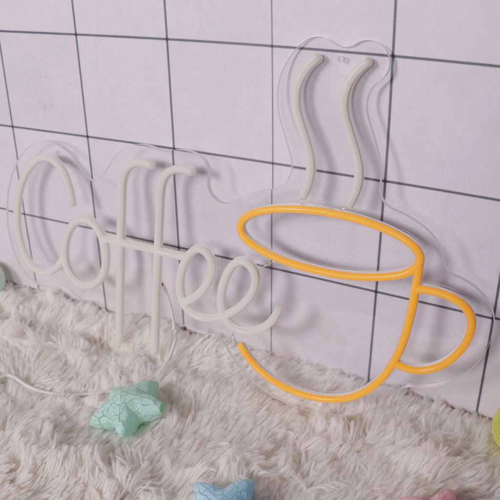 Neon sign with 'Coffee' text and a coffee cup shape on a checkered floor.