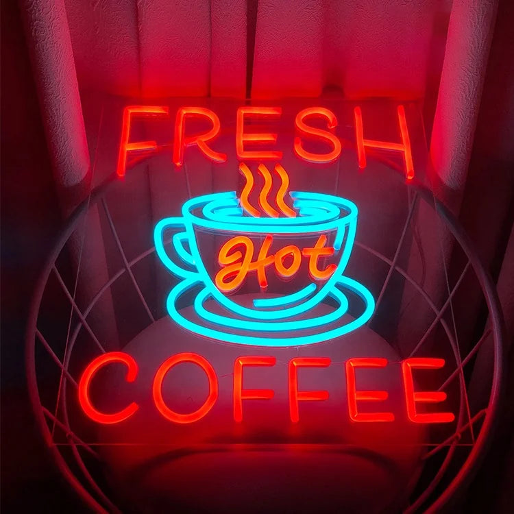Neon sign with a coffee cup and 'Fresh Hot Coffee' text on a dark background