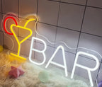 Neon sign with 'BAR' and cocktail glass on a tiled wall background