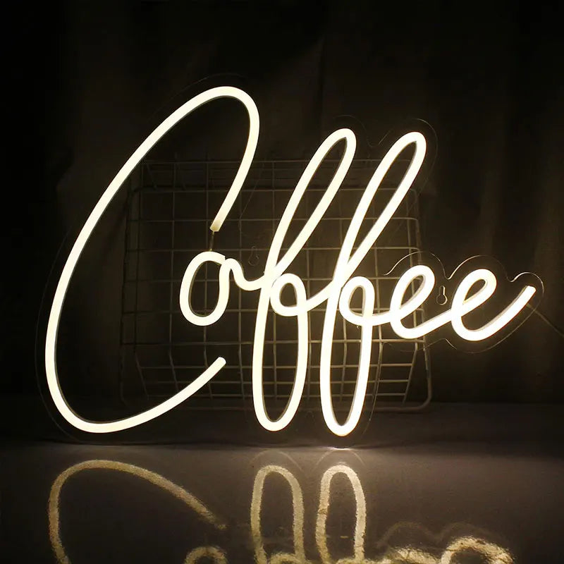 Neon sign spelling 'Coffee' on a dark background