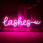 Neon sign with the word 'lashes' on a dark background
