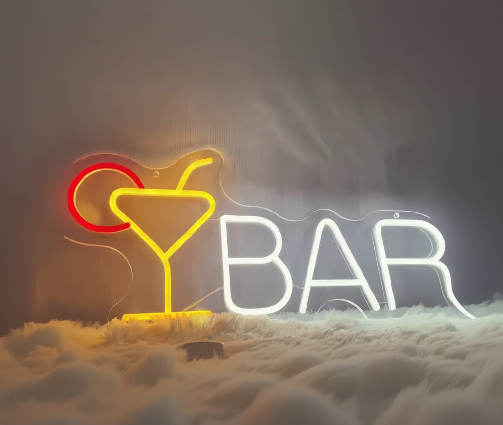 Neon sign with a cocktail glass and 'BAR' letters on a dark background