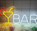 Neon sign with a cocktail glass and 'BAR' text on a tiled wall background