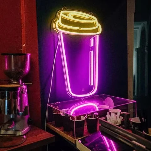 Neon sign of a coffee cup in a coffee shop setting