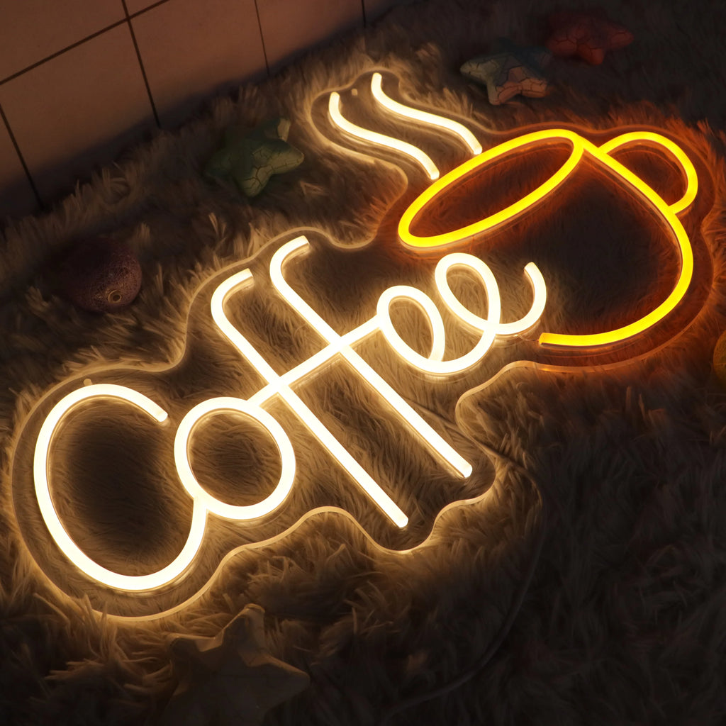 Neon sign with 'Coffee' and a coffee cup on a textured surface