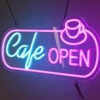 Neon sign that reads 'Cafe Open' with a dark background