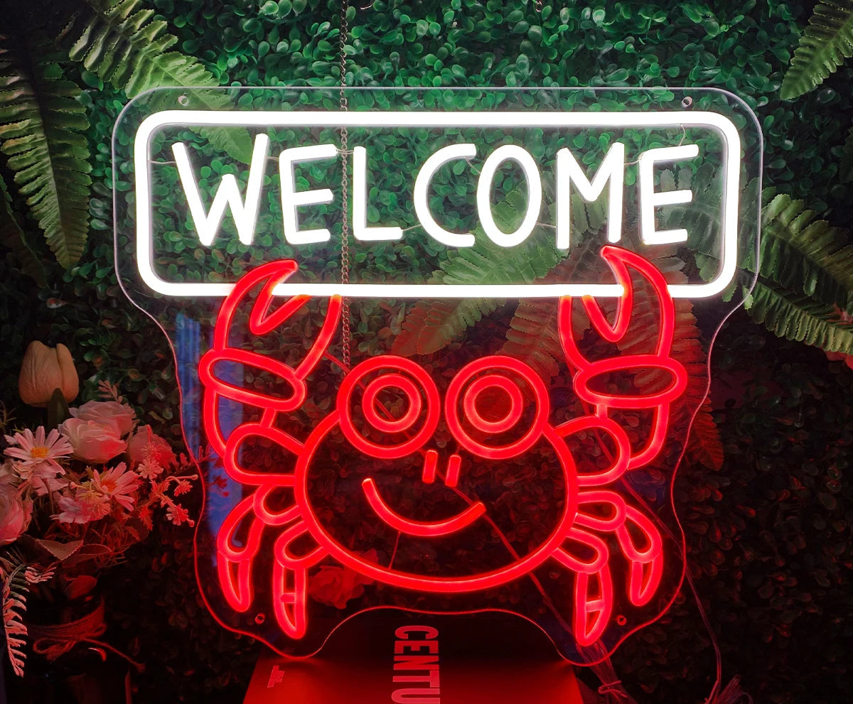 Neon sign with a crab design and 'WELCOME' text, surrounded by plants and flowers.